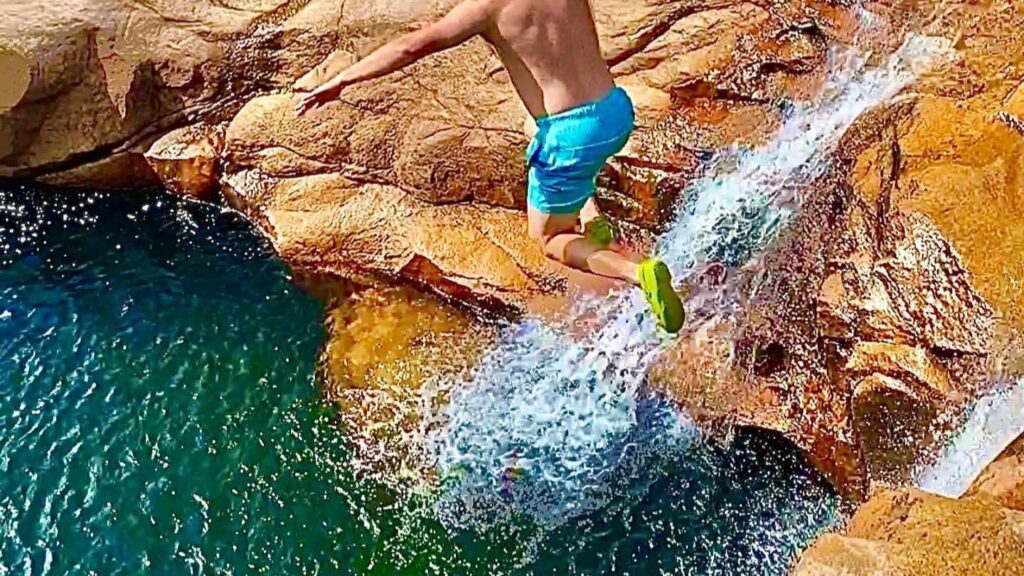 Local boy jumping into a swimming hole