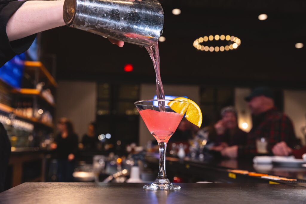 blood orange cosmopolitan pouring at night